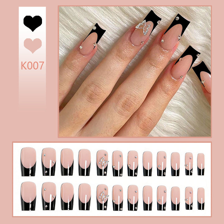 Acrylic nail set with elegant black and white design and glitter accents Stornfield