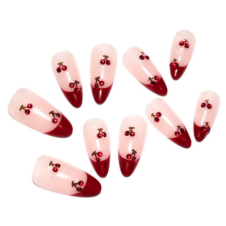 Artful stiletto nails with cherry motifs and glitter accents Stornfield