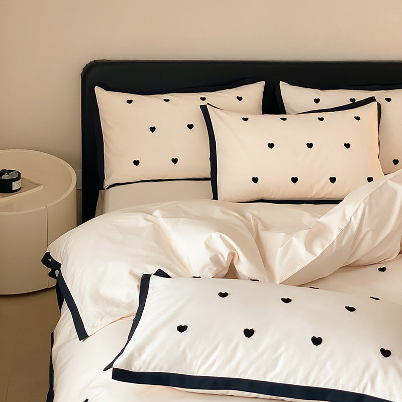 High-quality cotton satin bedding set with delicate embroidery, reversible feature & piping edge