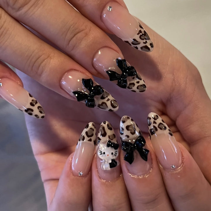 Artistic extension nails in leopard pattern with bow accents Stornfield