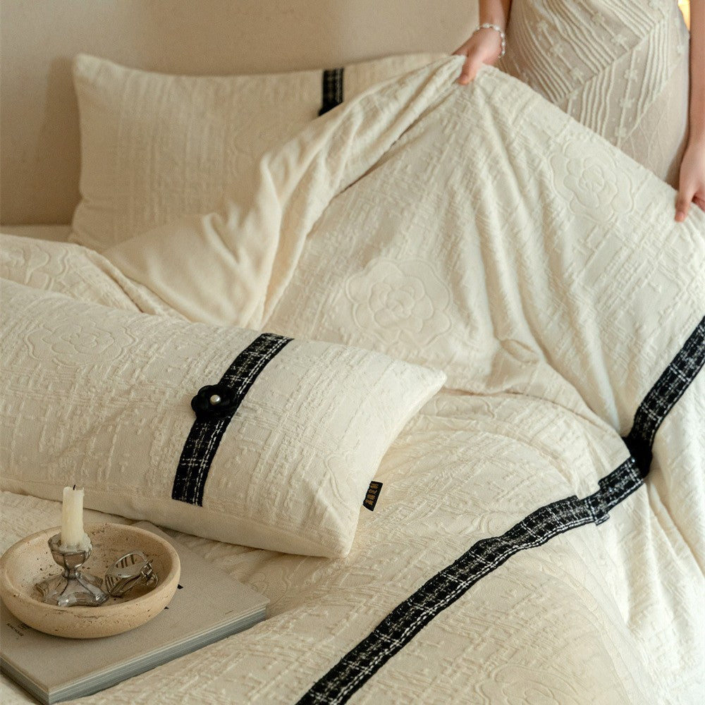 Quilted bedding set with decorative contrast ribbon and button closure