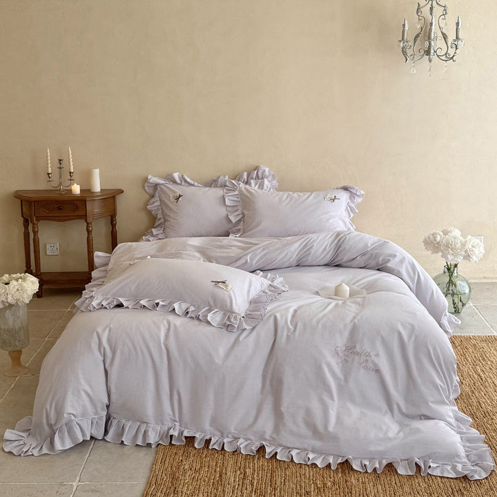 Ruffled bed linen set with fine striped texture and decorative frill