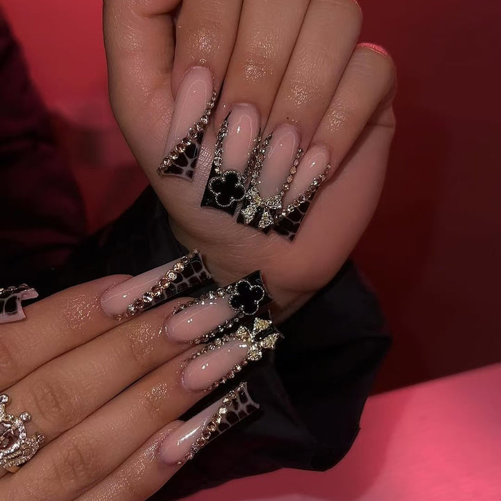 Glamorous artificial nails with elegant design with rhinestones and 3D decorations Stornfield
