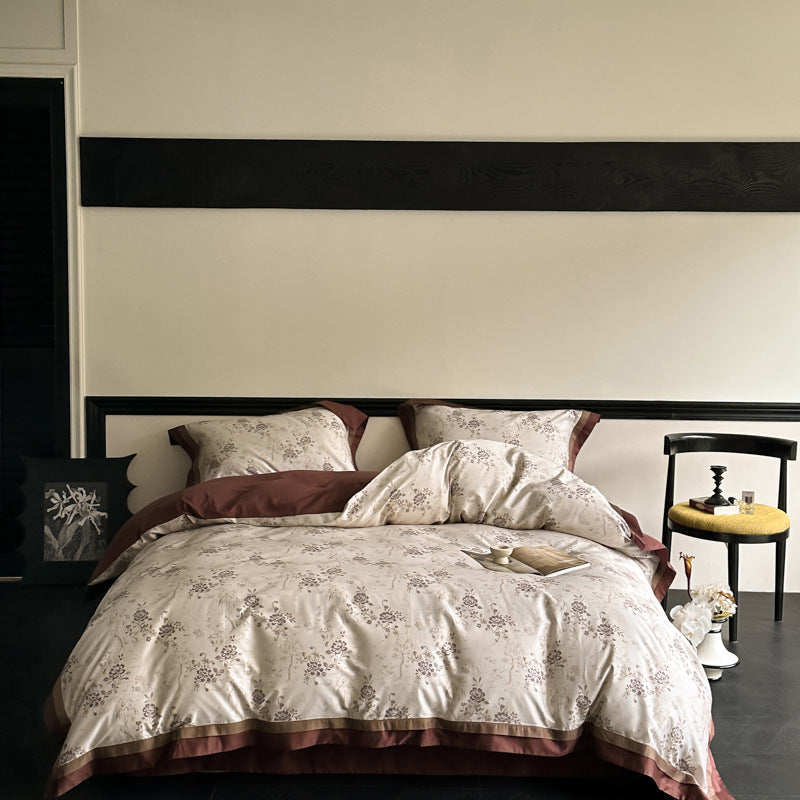 Reversible bedding set made of cotton satin with floral jacquard look and decorative hem