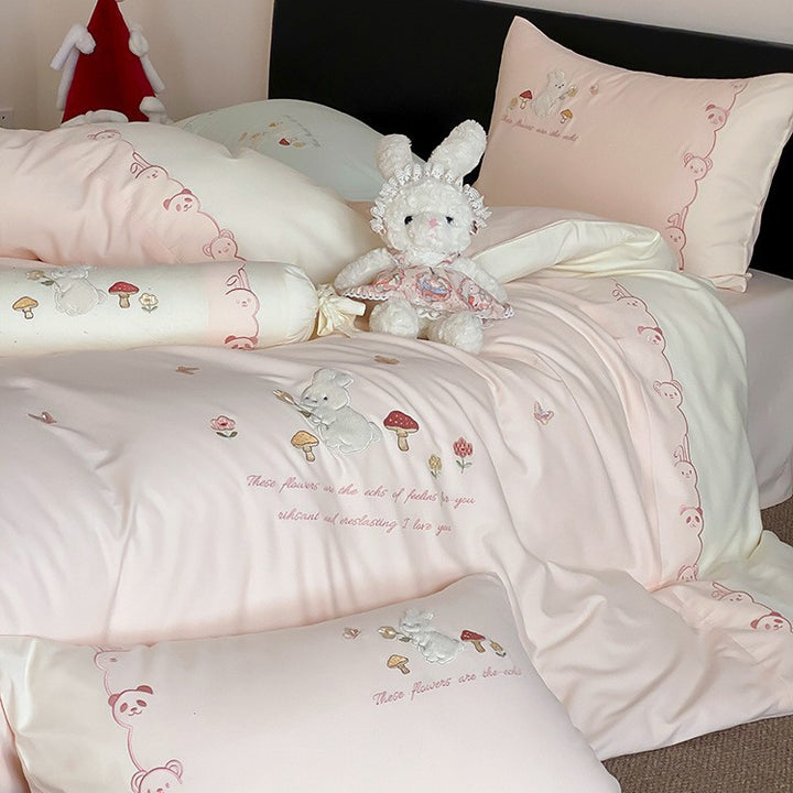 Playful cotton bedding set with plush bunny appliqué and round cushion