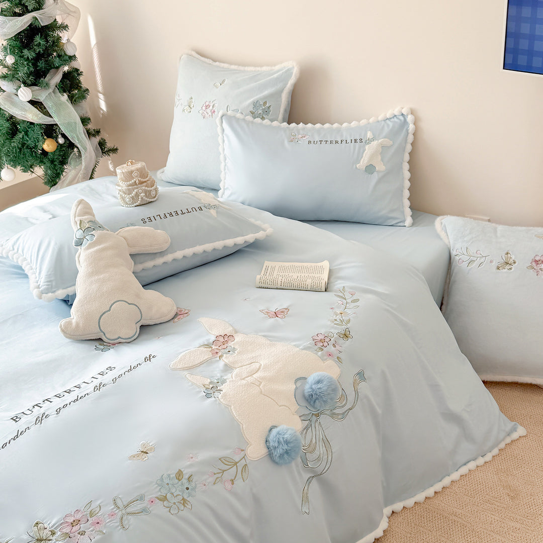 Playful cotton satin bedding set with appliquéd bunny pom-pom trim and floral embroidery