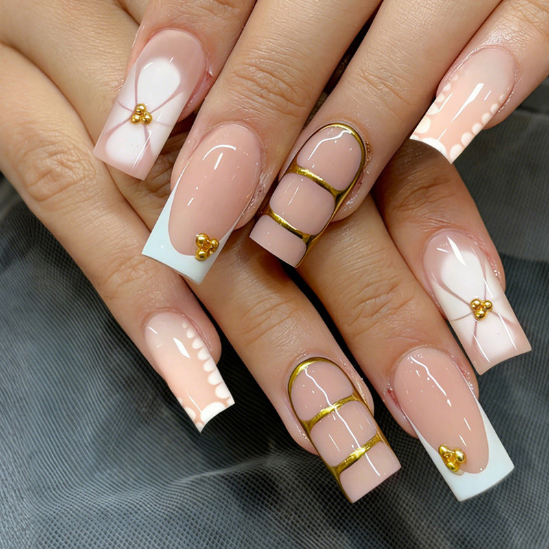 Artificial nail set with elegant gold embellishments and romantic accents Stornfield