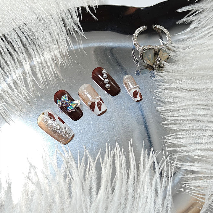 Artificial nails with glamorous rhinestone and bow design Stornfield