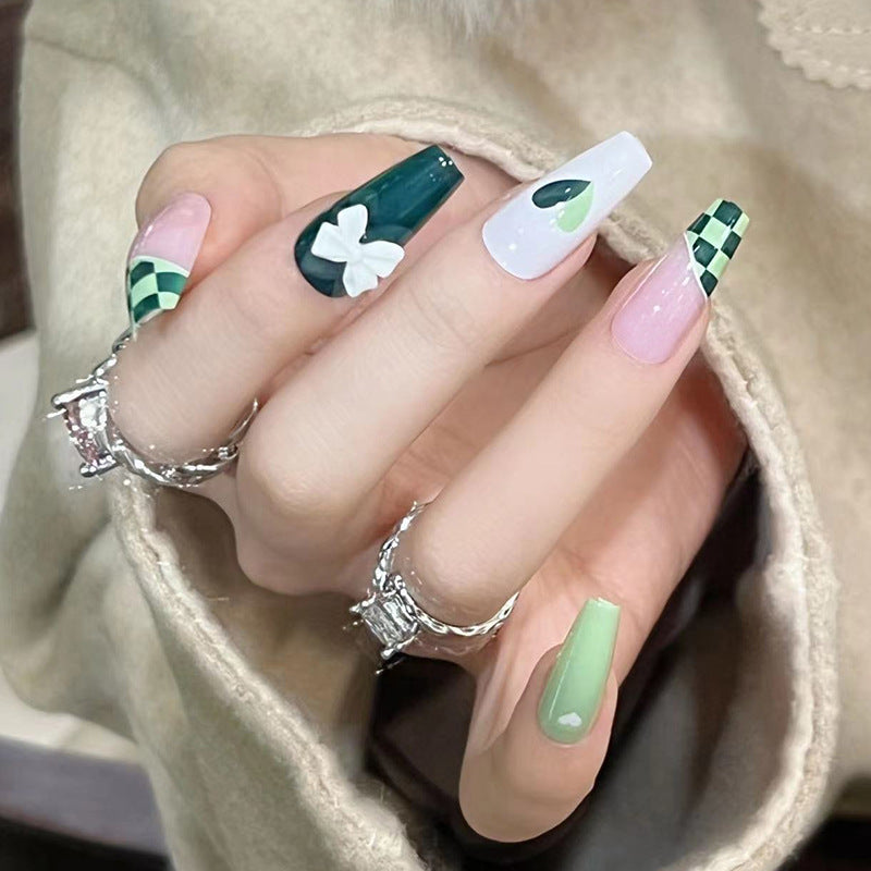 Artificial nail extensions with creative design and glitter accents Stornfield