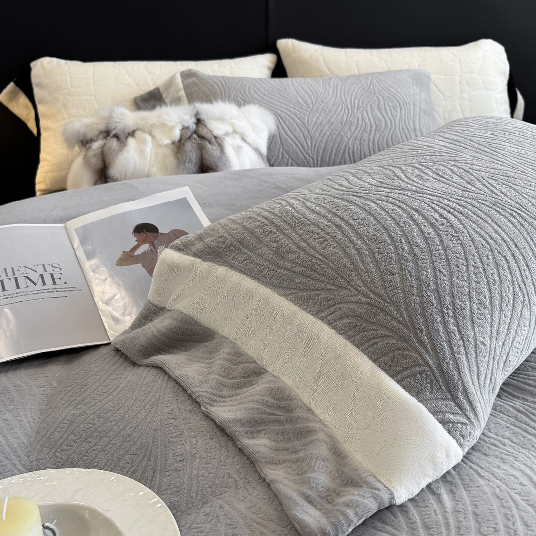 Quilted bedding set made of cotton blend with raised leaf texture and contrasting border