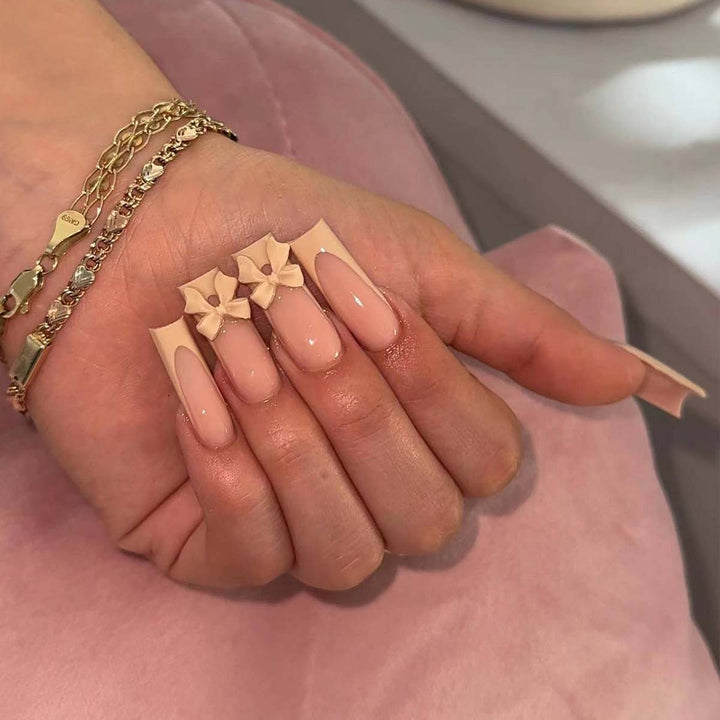 Artistic acrylic nails with bow decorations Stornfield