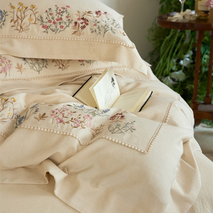 Romantic cotton satin duvet cover set with delicate floral embroidery and decorative pillow