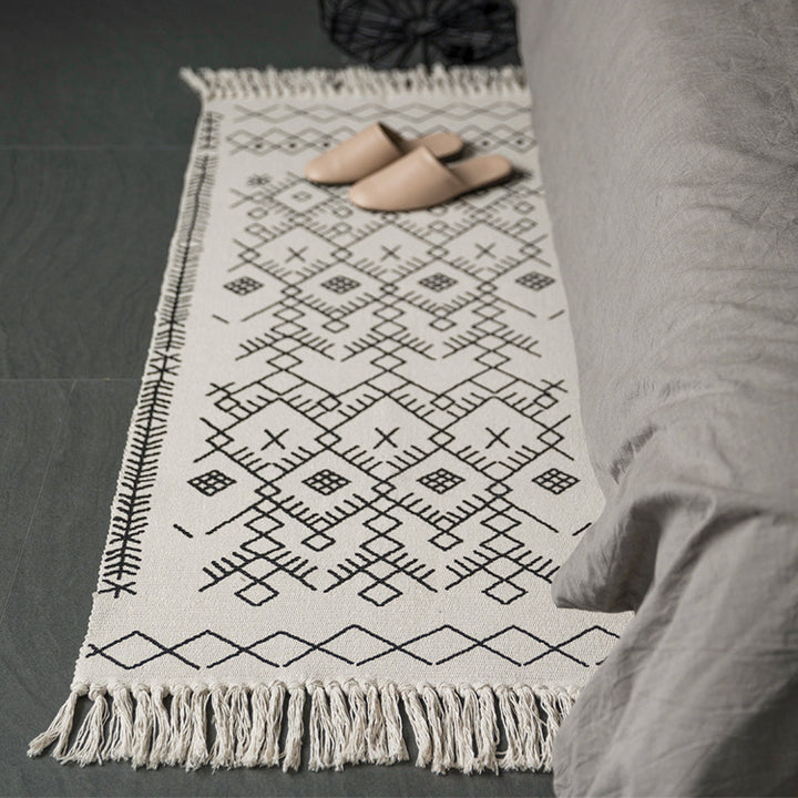 Woven cotton rug runner with flat weave structure, graphic diamond ethnic pattern and fringes