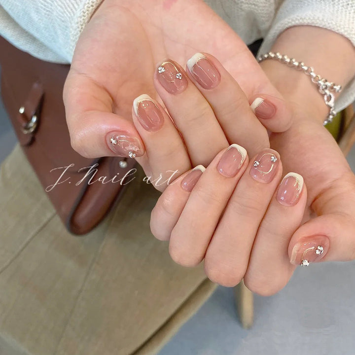 Acrylic nail set with elegant French tips and glitter accents Stornfield