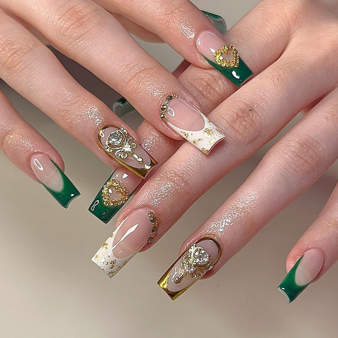 Exquisite artificial nails with gold embellishments and glitter accents Stornfield