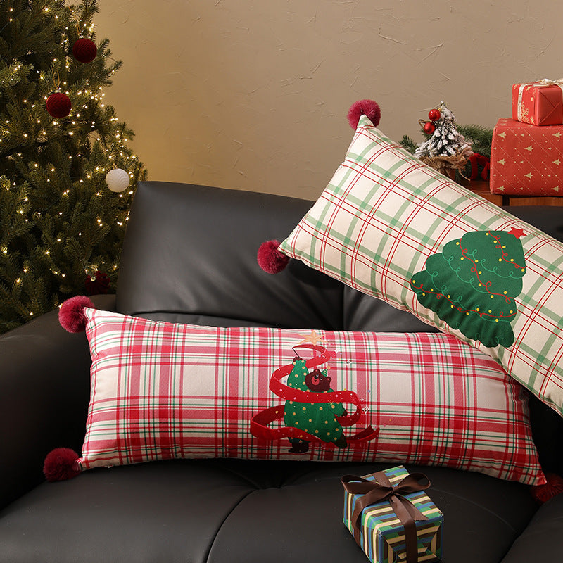 Long decorative lumbar and neck pillow in Christmas check with pompom and dog-tree motif Stornfield