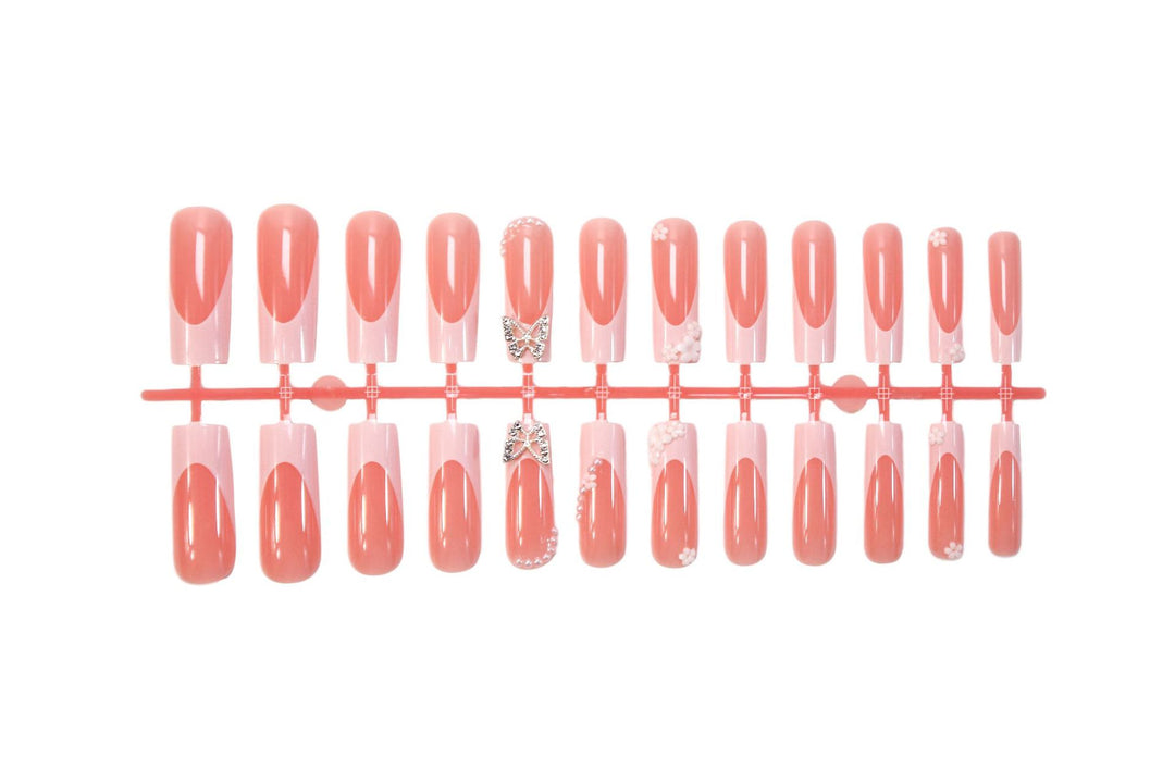 Artificial nail set with elegant floral decorations and glitter accents Stornfield