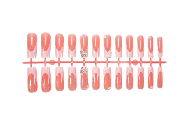 Artificial nail set with elegant floral decorations and glitter accents Stornfield