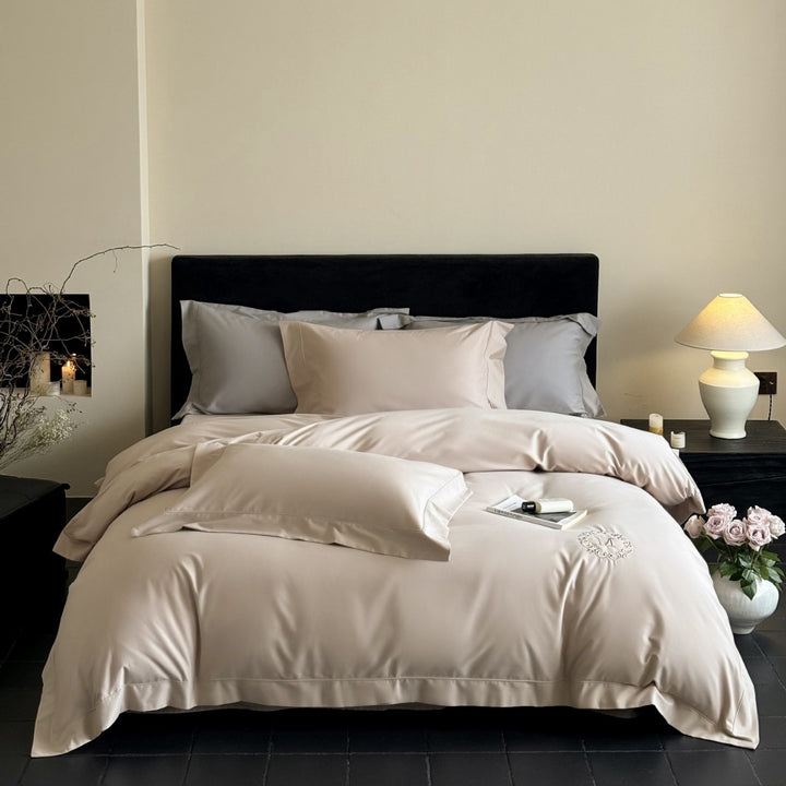 Luxurious cotton satin bedding set with monogram embroidery and fine piping