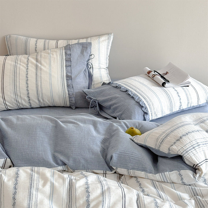 Striped bedding set made of washed linen-cotton mix with fine ribbon embroidery and tie band pillow