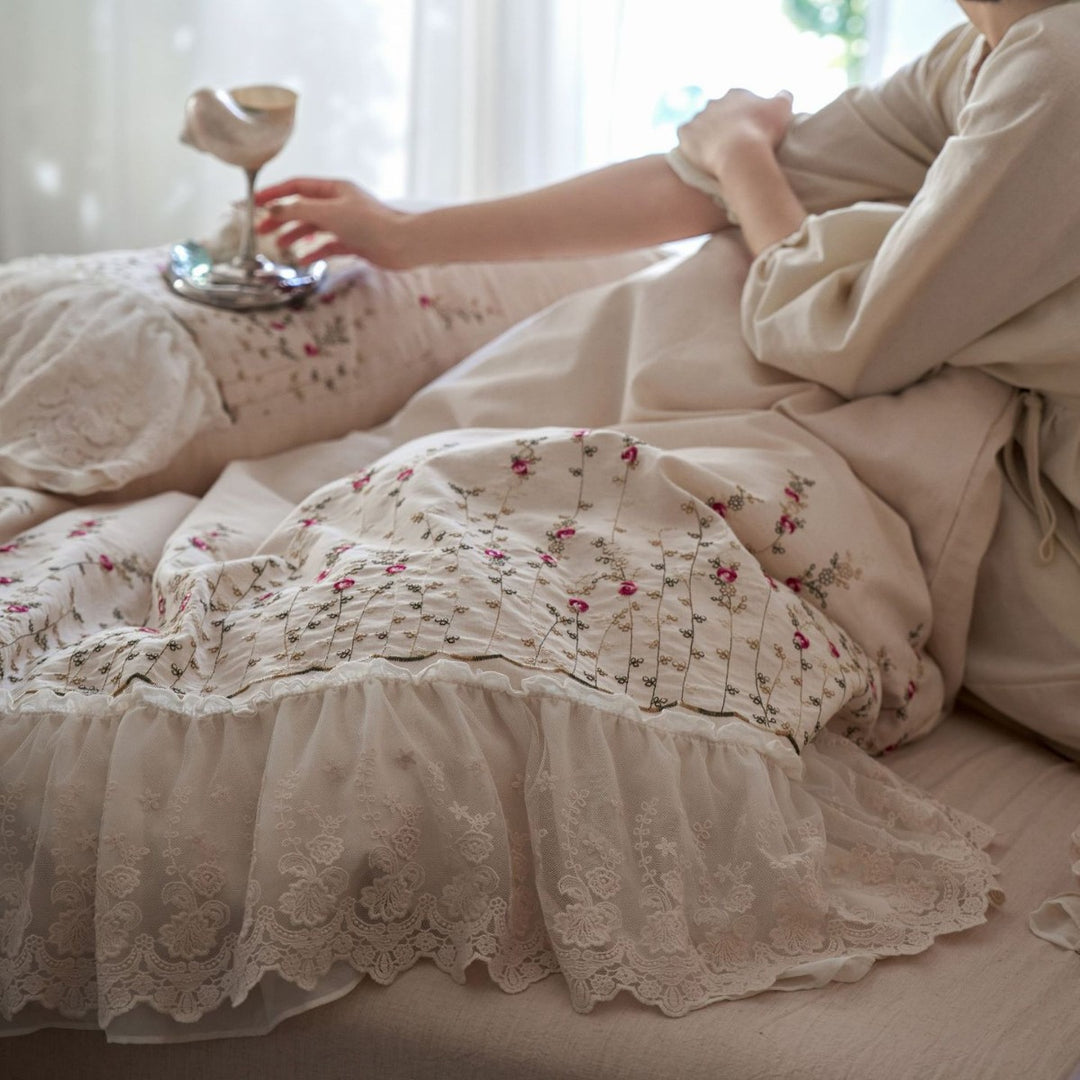 Vintage-inspired ruffled blanket and pillow set made of cotton muslin with delicate floral embroidery
