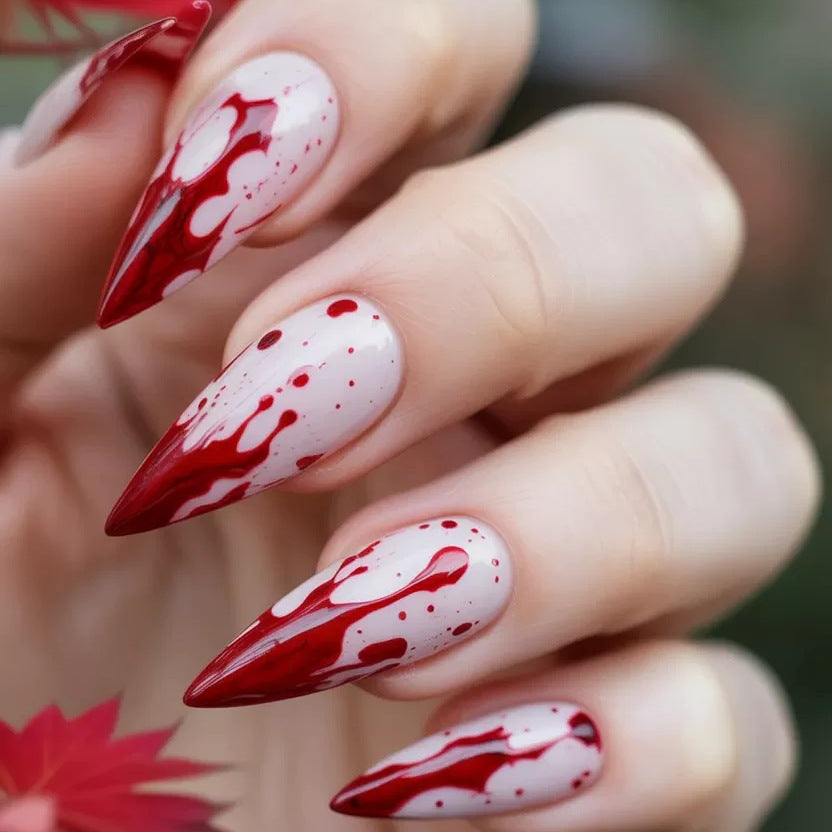 Artificial nail set with blood red inspired design and pointed accents Stornfield