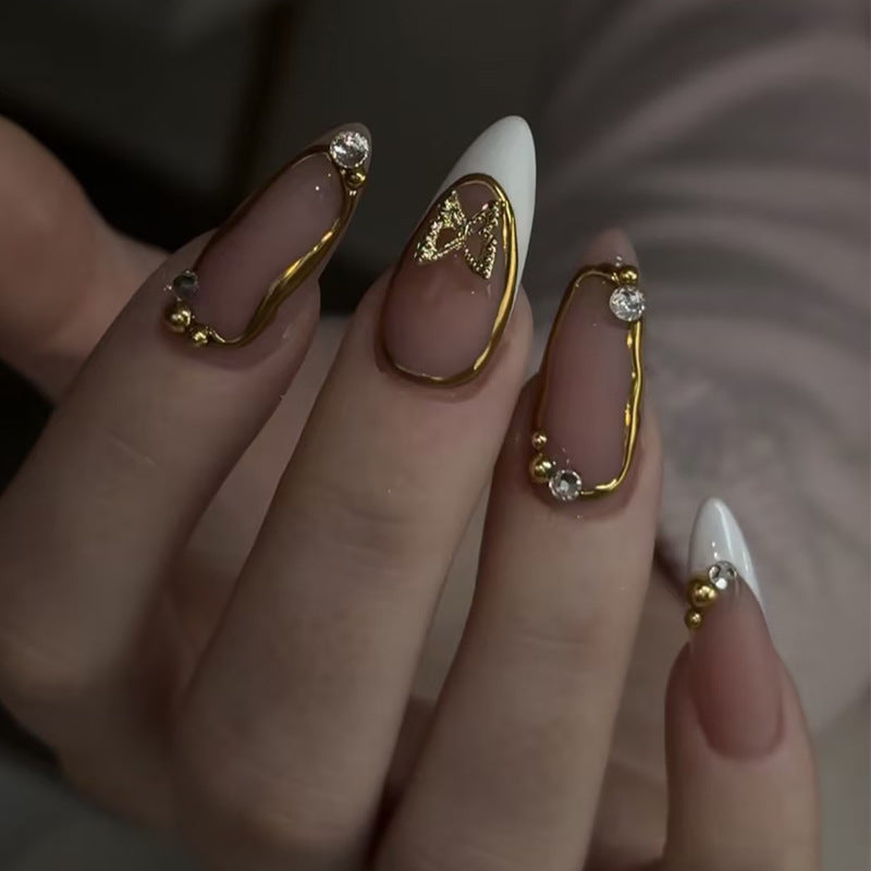 Artificial nail set with elegant gold accents and luxurious decorations Stornfield