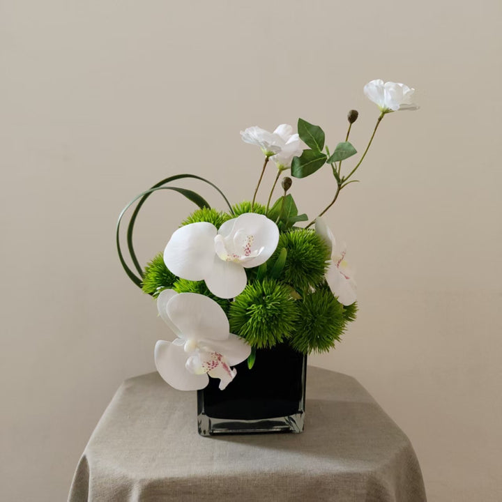 Lifelike Orchid and Greenery Floral Arrangement