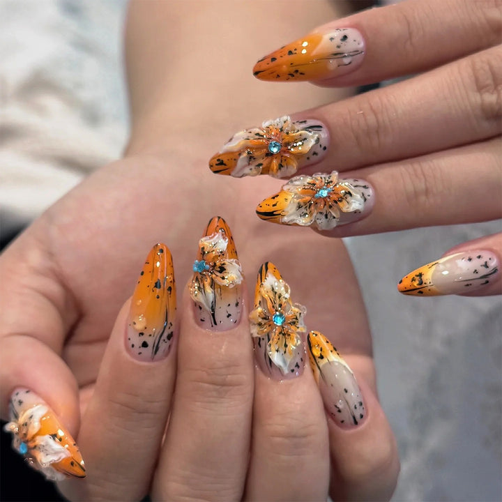 Artificial nail set with elegant floral design and sophisticated glitter elements Stornfield