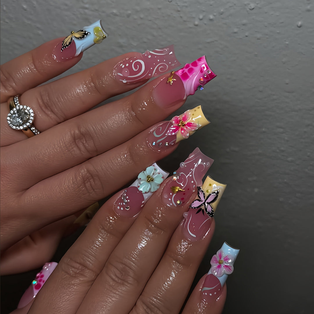 Artistic nails with floral accents and glitter clusters Stornfield