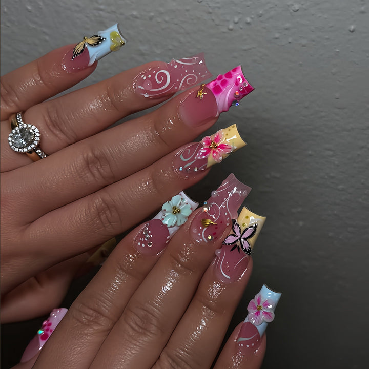 Artistic nails with floral accents and glitter clusters Stornfield