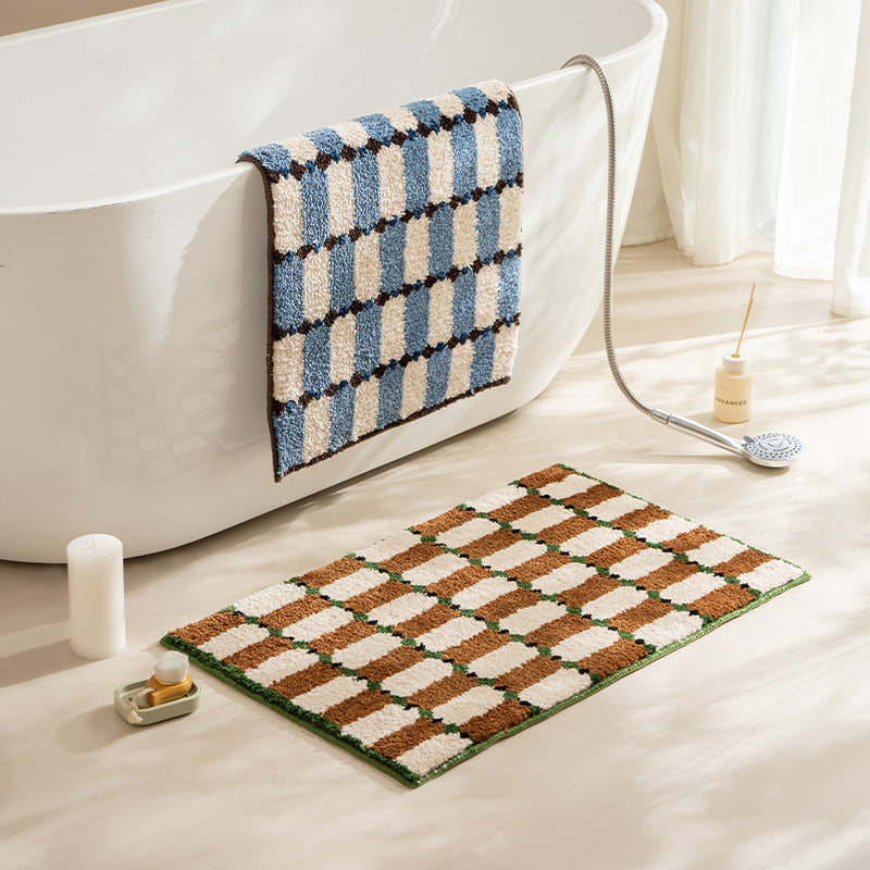 Hand-tufted bathroom mat with a velvety pile, non-slip latex backing, and geometric honeycomb check pattern Stornfield