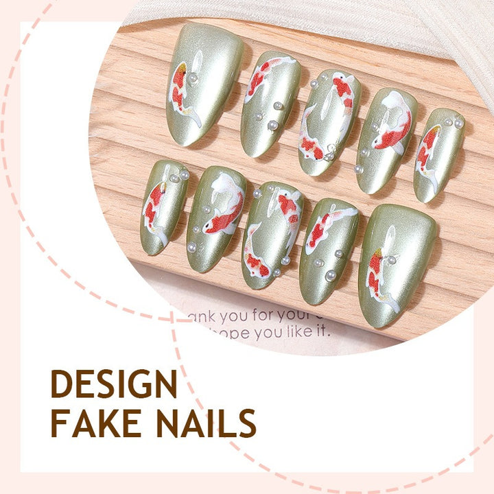 Artificial nail set with filigree koi fish designs and glitter accents Stornfield