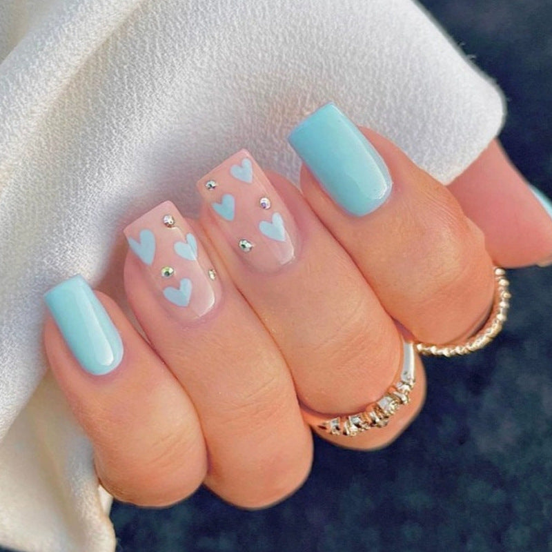 Nail art with heart designs and glitter accents Stornfield
