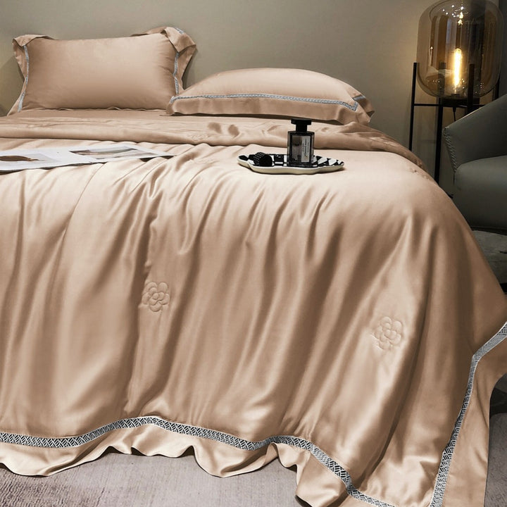 Luxurious satin bedding set with fine embroidered border and tone-on-tone floral relief
