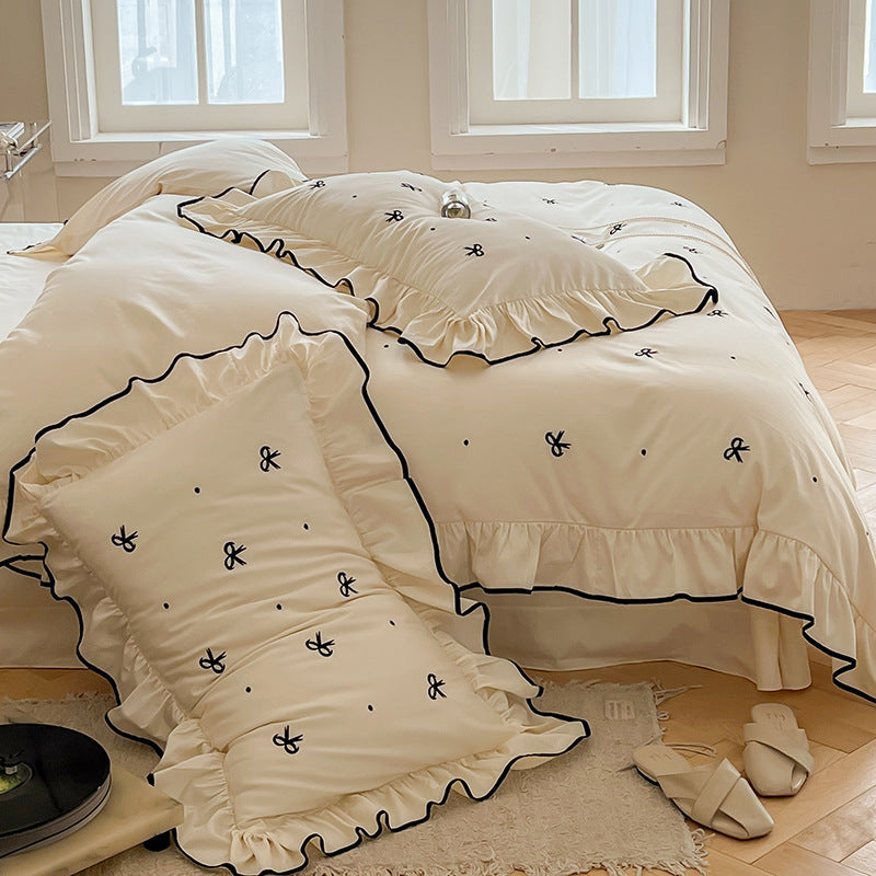 Exclusive bedding set in romantic style with ruffle, subtle bow embroidery, and breathable cotton satin