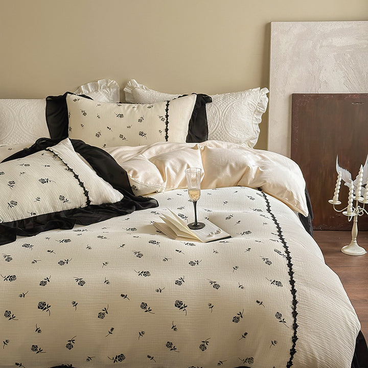 Country house bedding set with quilted bedspread, delicate rose print and ruffle trim