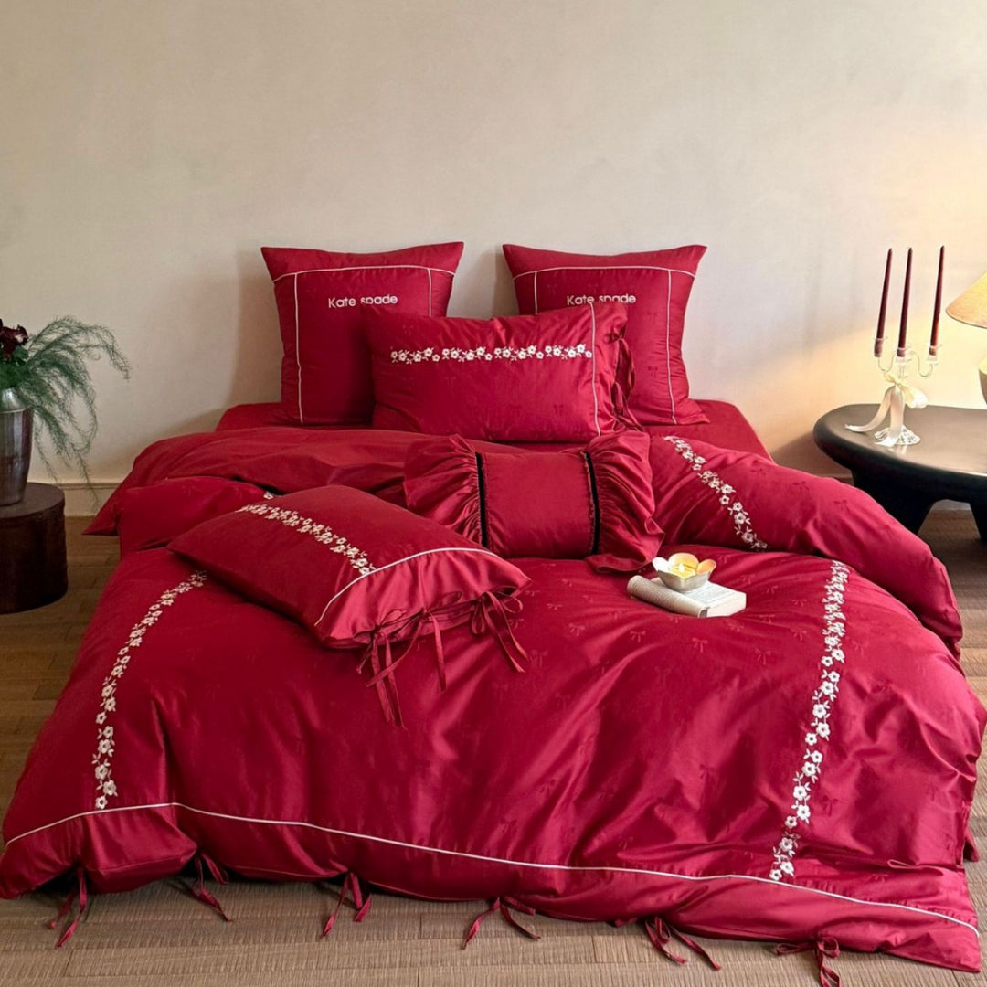 Bedding set made of cotton satin with floral border embroidery, decorative bows and pillow ensemble