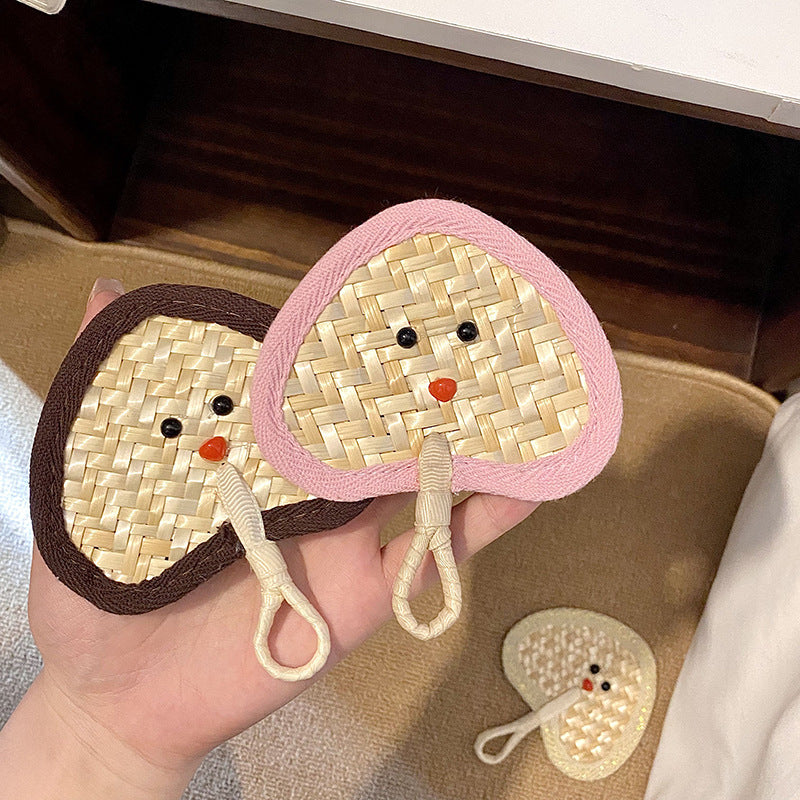 Handcrafted fan with playful face motif Stornfield