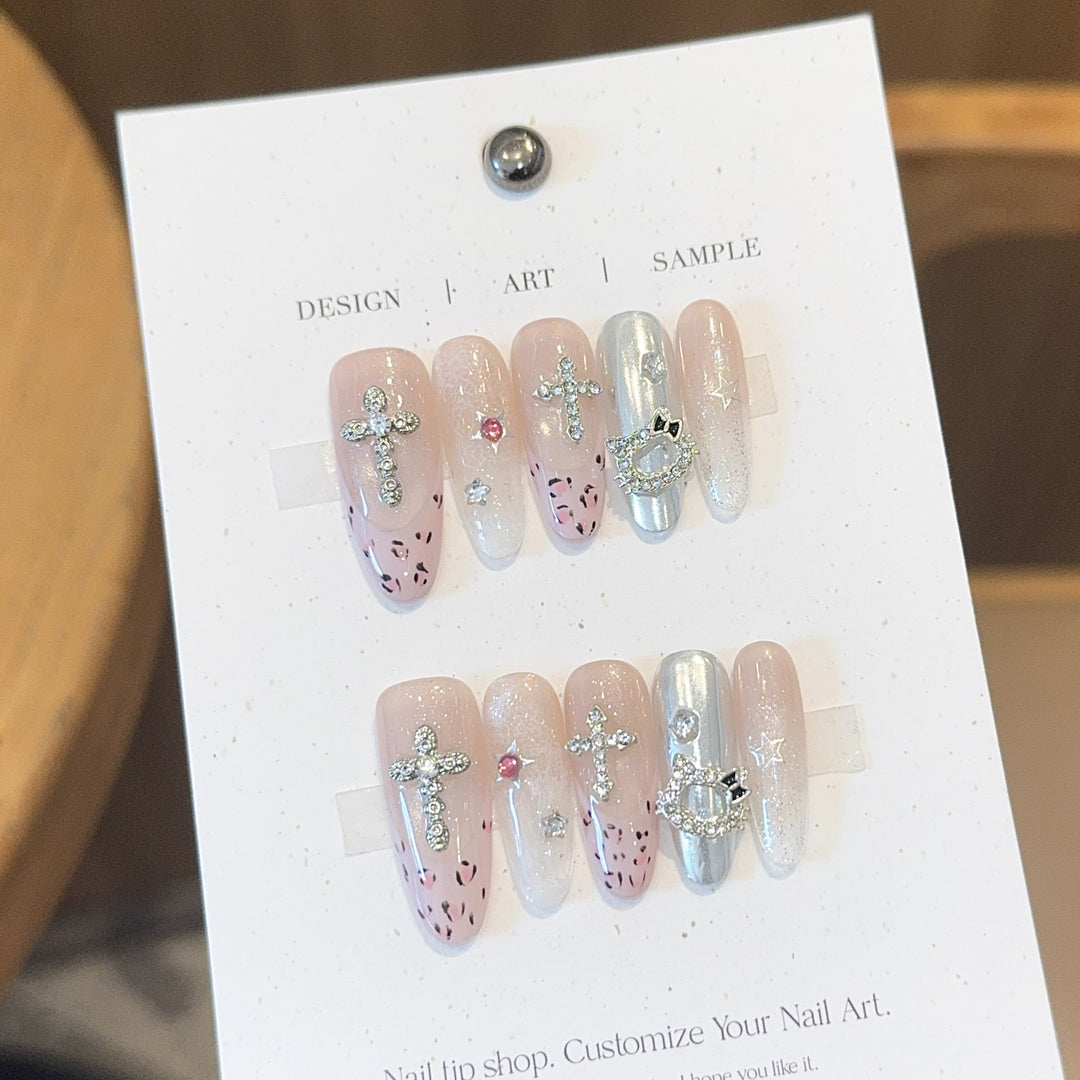 Artificial nails with sparkling rhinestones and cross motifs Stornfield