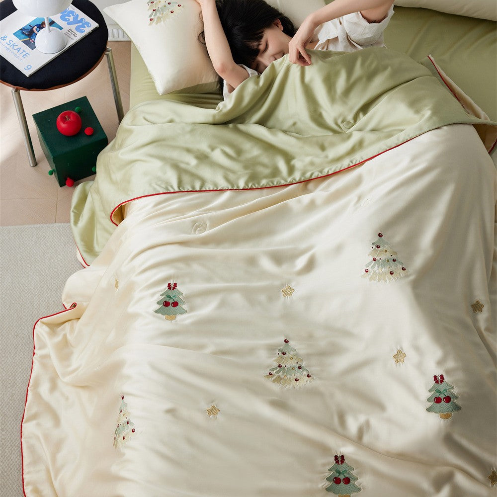 Luxurious satin bed linen set with embroidered Christmas tree motifs and contrasting piping