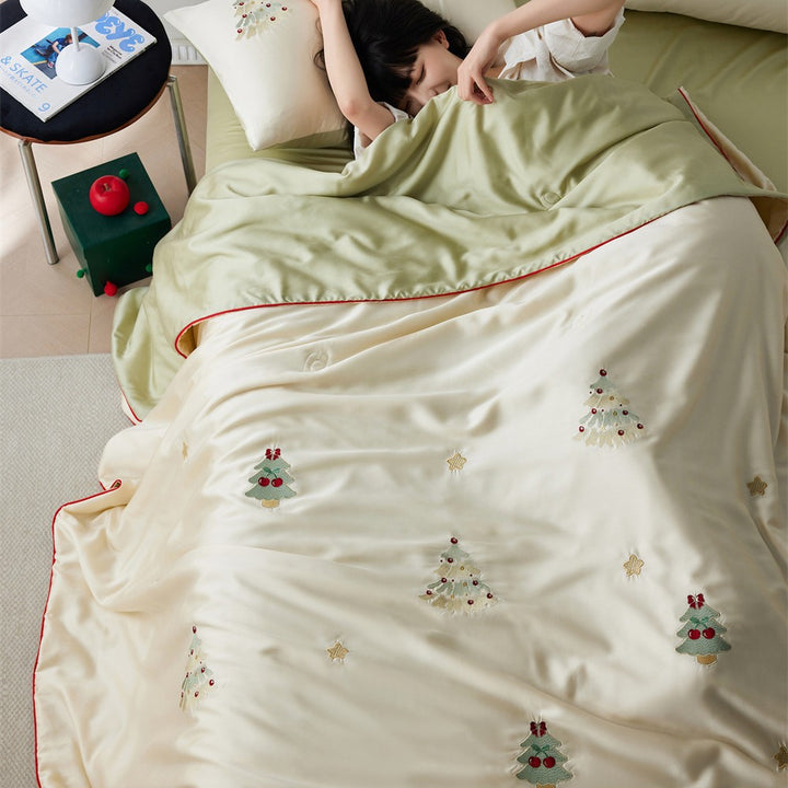 Luxurious satin bed linen set with embroidered Christmas tree motifs and contrasting piping