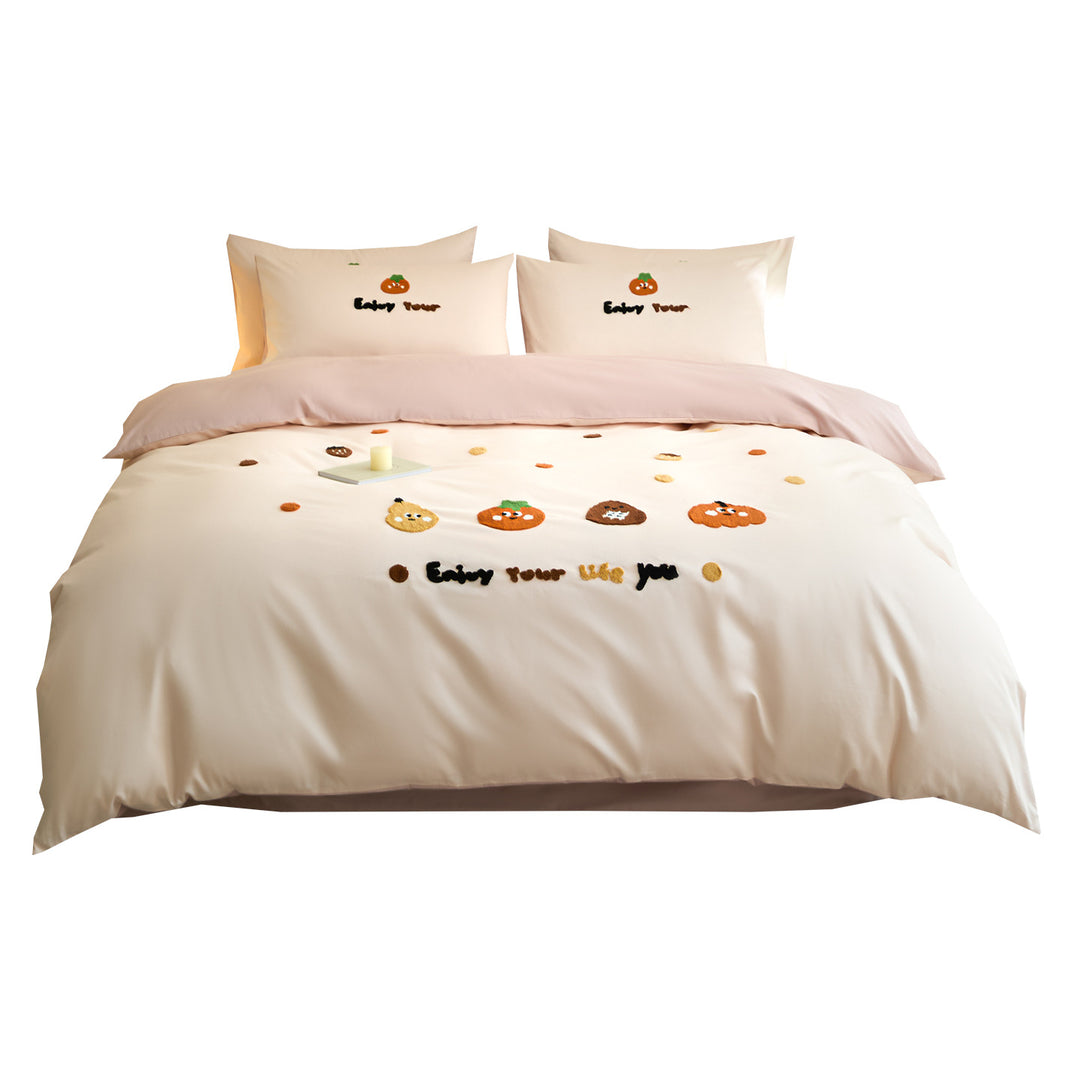 Embroidered bedding set with cute pumpkin appliqués and reversible functionality