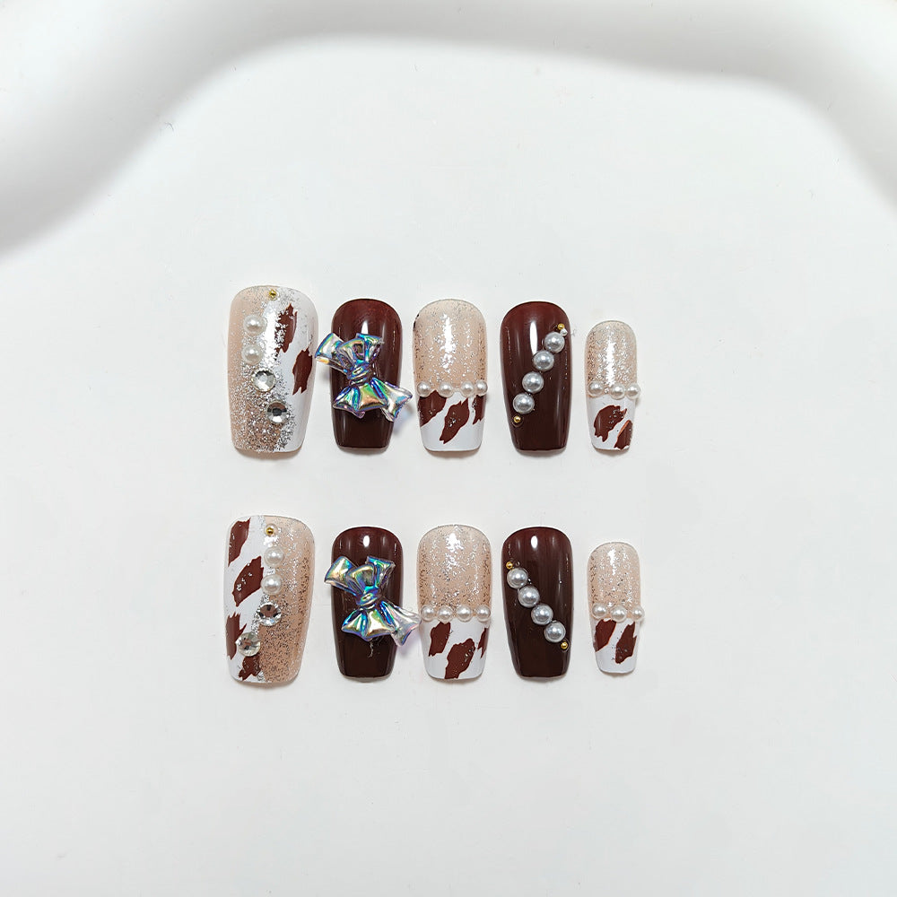 Artificial nails with glamorous rhinestone and bow design Stornfield