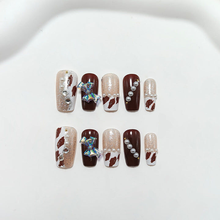 Artificial nails with glamorous rhinestone and bow design Stornfield