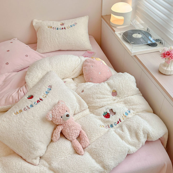 Plush quilt with teddy fleece, embroidered strawberry appliqués and reversible function