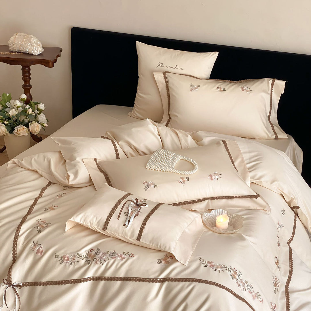 Embroidered bed linen set made of cotton satin with lace trim and floral appliqués