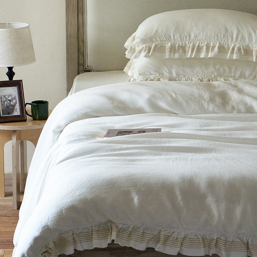 Cotton muslin duvet cover and pillowcase set with ruffle trim and finely striped piping