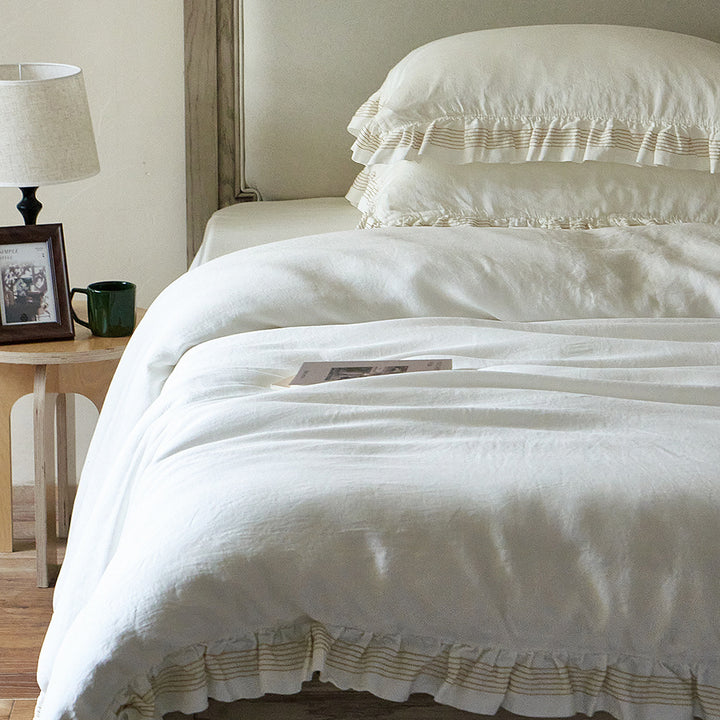 Cotton muslin duvet cover and pillowcase set with ruffle trim and finely striped piping
