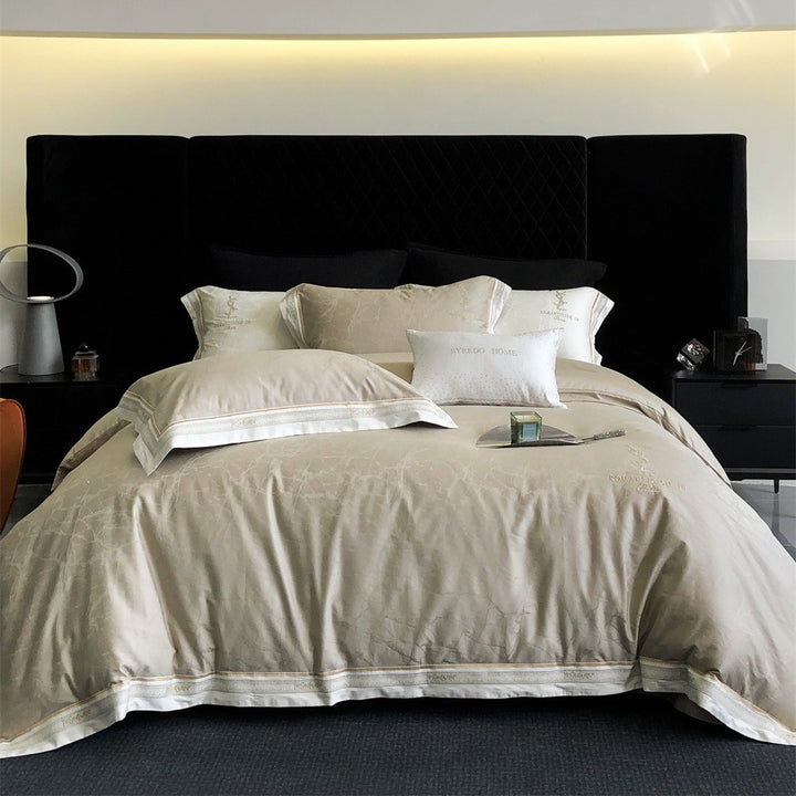 Luxurious satin bedding set with subtle marble texture and golden embroidered border
